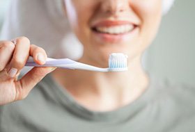 a person smiling before brushing their teeth