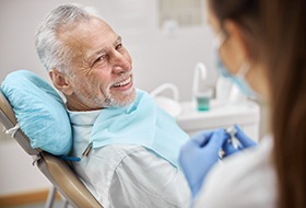 Man listening to dentist talk about cost of tooth extractions in Wethersfield