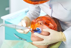 Dental patient receiving tooth-colored filling  