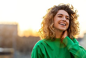 Happy, confident young woman standing outside