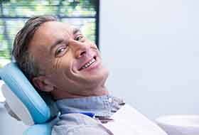 a man smiling during his dental appointment