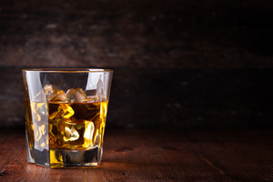 Glass of whiskey with ice cubes